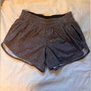 Size M grey and black 4” Lululemon shorts with a zipper pocket!